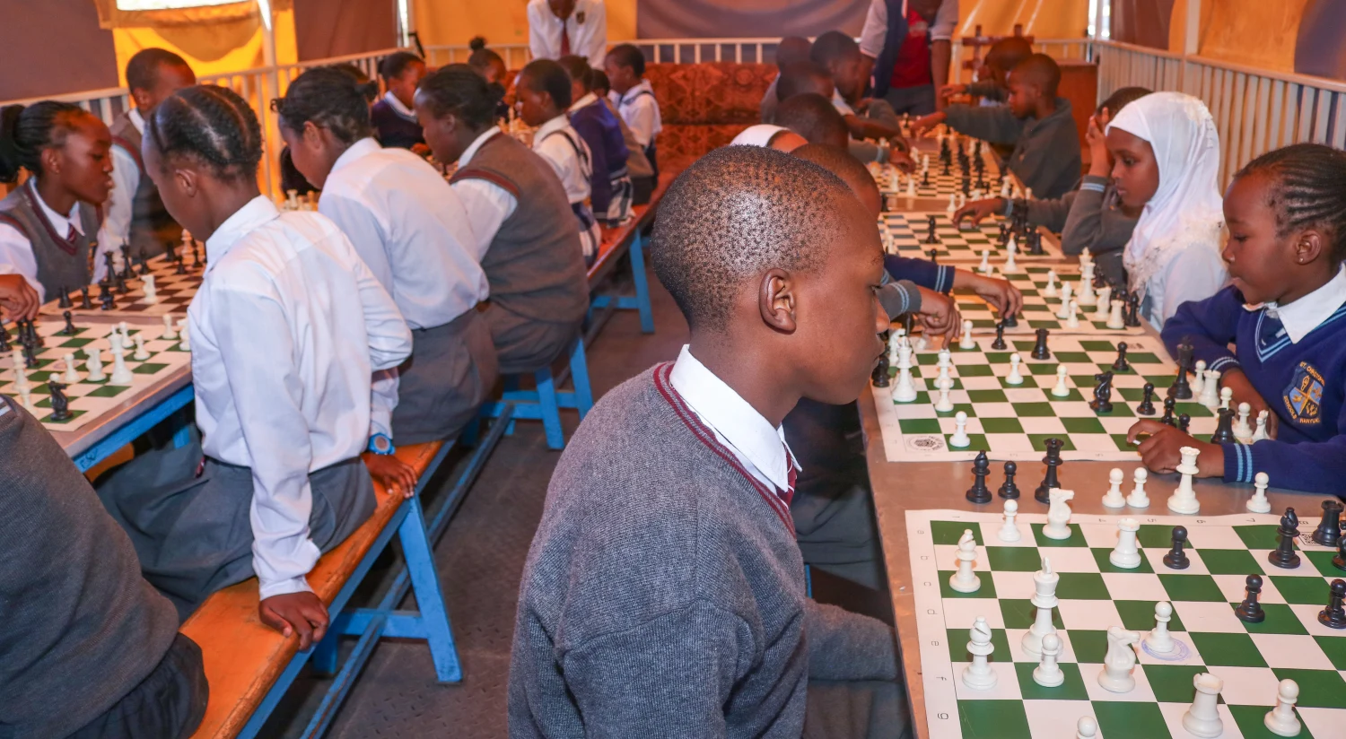 A full chess hall with students concentrating on their games