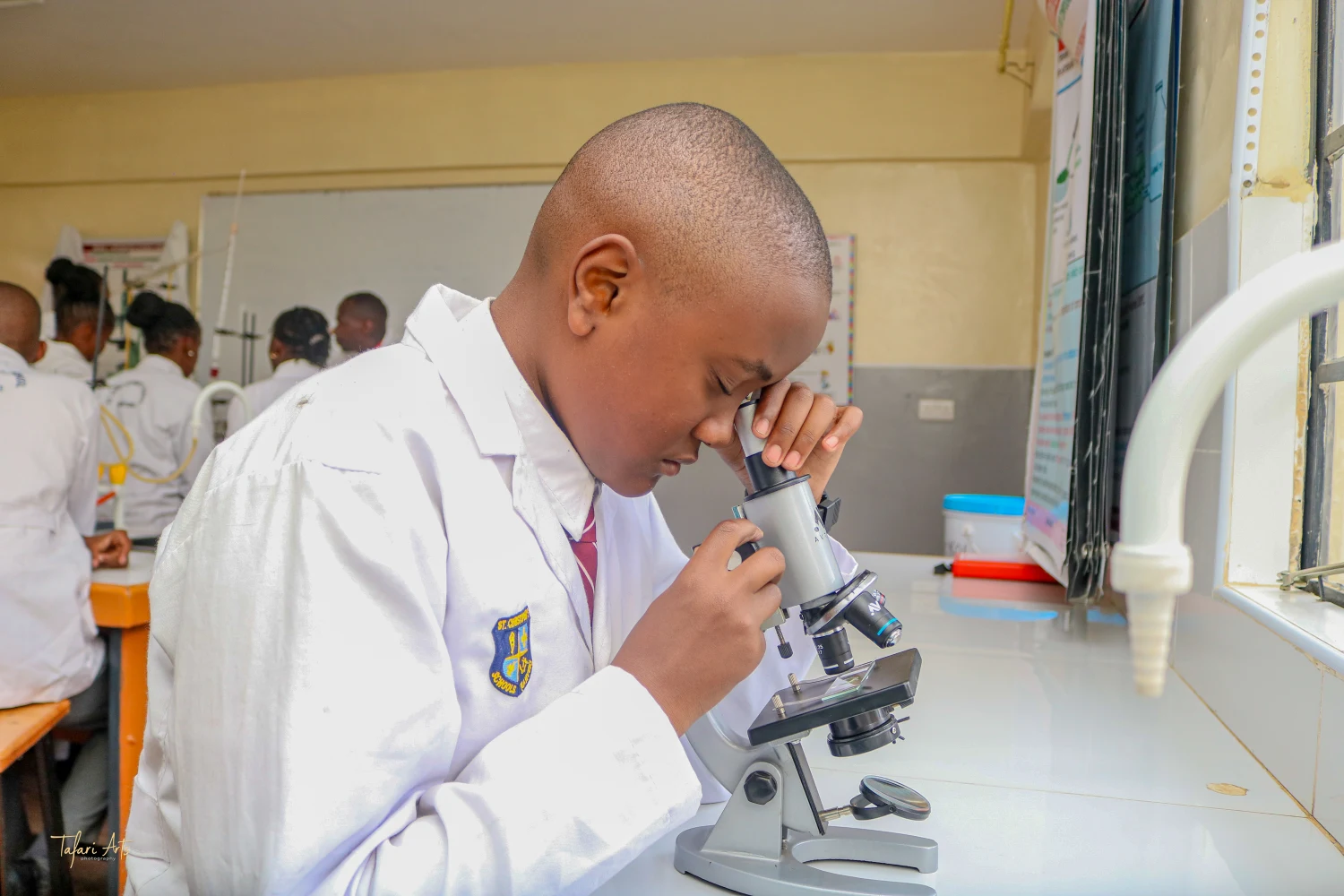 Student using a microscope in the science lab at St. Christopher's