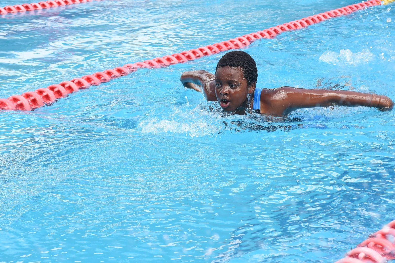 A St. Christopher's swimmer racing in butterfly stroke at the Laikipia Aquatics Invitational